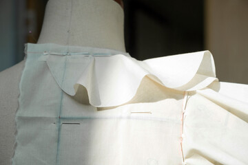 Dressmaking mannequin with pinned fabric showcases fashion design, pattern-making, tailoring. Ideal...
