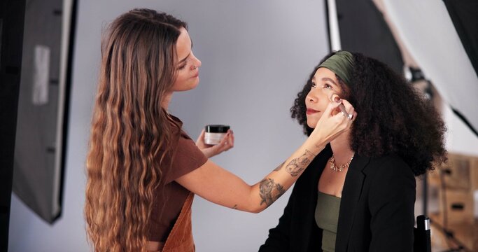 Makeup, stylist and ready woman for photoshoot, behind the scene and process for production. Cosmetics, blush powder and crew artist with skills for glamour, apply highlighter and touch up model