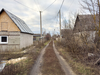 A road with a few houses on either side