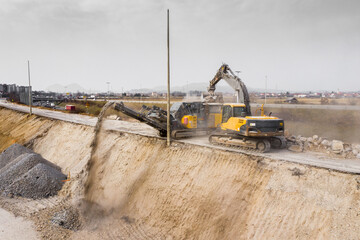 excavator, rock crusher, gravel processing, highway construction, construction site, heavy machinery, roadwork, industrial equipment, crushed stone, recycling, aggregate, earthmoving, construction ind