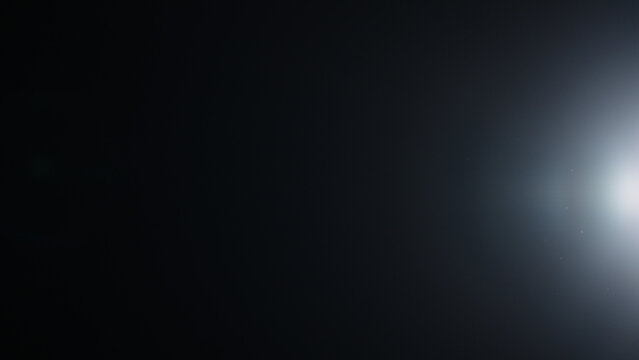 Real optic lens flare over black background for overlay or background
