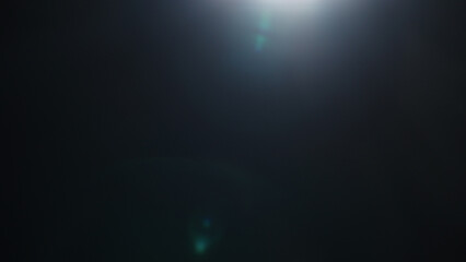 Real optic lens flare over black background for overlay or background