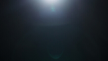 Real optic lens flare over black background for overlay or background