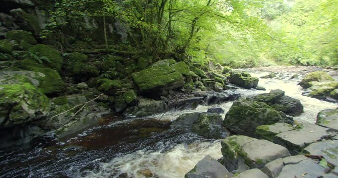 Panning left shot of the river Mellte at the entrance of Porth yr Ogof Cave.