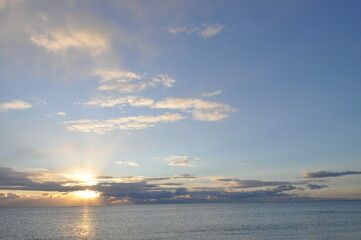 Celestial Harmony: Light and Clouds Dance Over the Horizon.