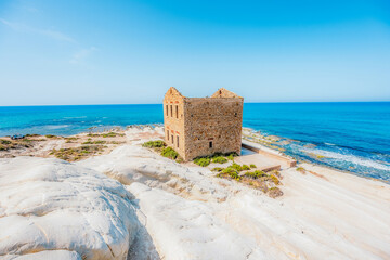 Punta Bianca, near Agrigento in Sicily Italy. Beach with ruins of an stone house on white cliffs.