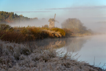 Wooden mill on an autumn foggy morning. Mikhailovskoye, Pushkin Mountains, Russia
