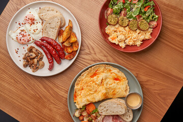 A close-up of a breakfast plate, showcasing the crispy bacon, fluffy scrambled eggs, and fresh salad. The variety of textures and flavors make this meal a delight for the senses.