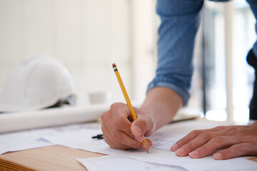 Young architect sketching house plans