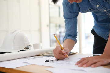 Young architect sketching house plans