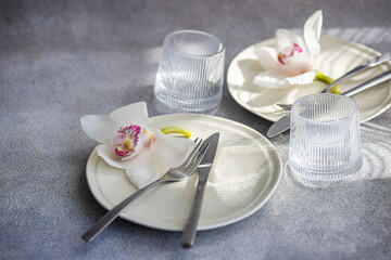 Table setting with fresh orchid flowers