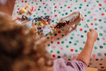 toddler with brown curly hair enjoying creative play