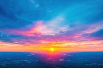 Obraz premium Colorful sunset over calm ocean waters with clouds reflecting the vibrant sky at twilight