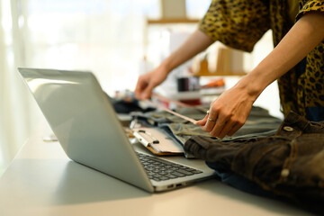 Close up of designer measuring denim pants preparing for a new design concept