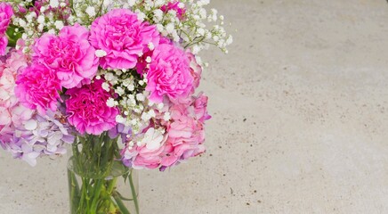 pink and white flowers on a concrete background