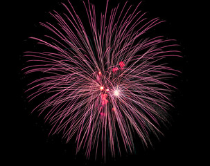 Colorful celebration fireworks isolated on a black sky background.
