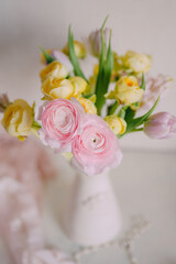 Soft Pastel Ranunculus and Yellow Roses in a Glass Vase