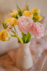 Soft Pastel Ranunculus and Yellow Roses in a Glass Vase