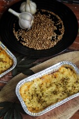 Delicious mashed potatoes bolognese in an aluminum foil bowl