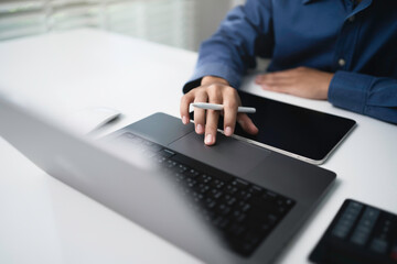 Businessman using working on laptop computer at office for searching the information with internet...