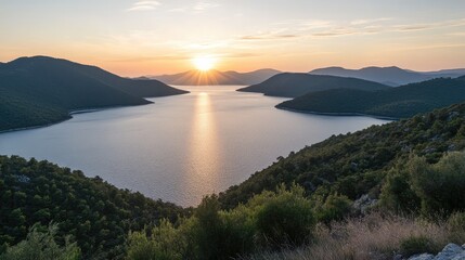 Obraz premium A sunrise over a vast lake, with warm hues painting the sky and water
