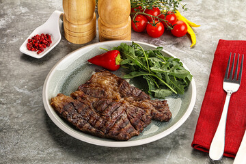 Grilled chuck roll steak with arugula