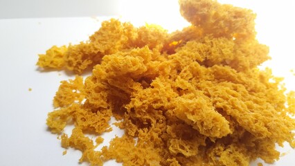 Pile of Crispy Fried Chicken Skin Cracklings, Traditional Indonesian Snack, Isolated on White...