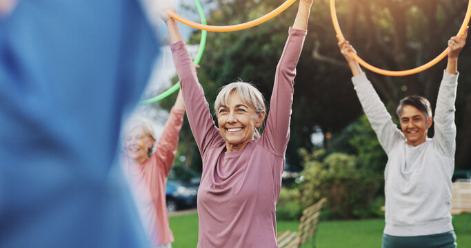 Exercise, senior people and fitness with hoop for physical workout, wellness and rehabilitation. Retirement, coach and group of elderly friends for training, wellbeing and stretching with ring toys