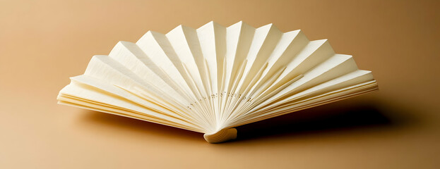 Beige paper fan, brown background