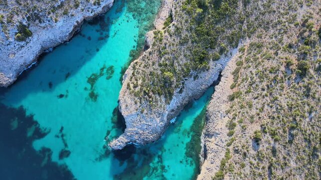 Explore the breathtaking turquoise waters and rocky coastline of Cala Varques, a hidden gem near Porto Cristo. Ideal for nature lovers and adventure seekers visiting Majorca.