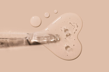 pipette drop of serum test on a beige background
