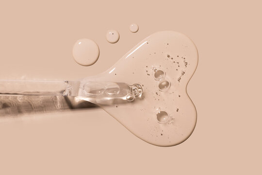 pipette drop of serum test on a beige background