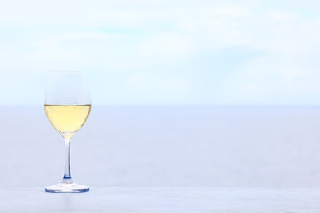 a glass of white wine on the background of the sea relaxing by the sea with wine