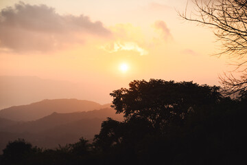Fototapeta premium landscape and travel concept with sunrise and layer of mountain and mist with forest on morning