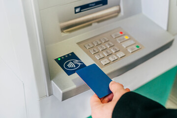 Man tapping card on ATM wireless sensor