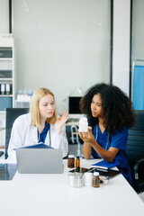Fototapeta premium Doctors and nurses using laptops and clipboards, showcasing teamwork, modern healthcare.