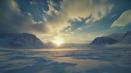 A serene winter landscape at sunset, showcasing mountains and a vast snowy expanse.