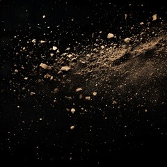The image features a cloud of scattered earth and debris against a black background, suggesting an explosion or impact. Small particles and larger clumps are seen suspended mid-air.