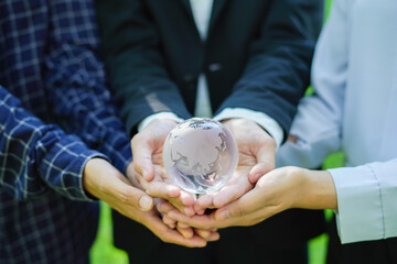  team embraces the world, symbolizing sustainability conservation, and cooperation. Hands together...
