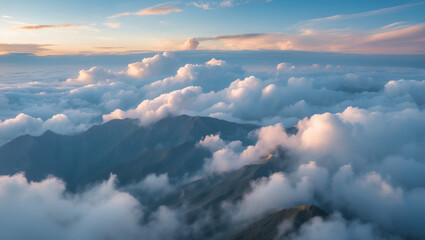 Fototapeta premium A landscape photograph capturing a breathtaking aerial view of a mountainous region enveloped in clouds, with soft and diffused lighting, creating a serene and tranquil atmosphere