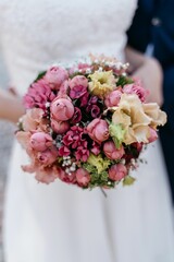Bridal bouquet with pink and peach flowers.