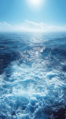 Serene ocean waves glistening under a bright sun with distant clouds on a clear day