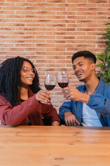 Joyful Couple Celebrating Together with Cheers of Red Wine in Elegant Glasses While Enjoying Their Special Moments of Happiness and Connection on a Memorable Evening Filled with Love and Togetherness