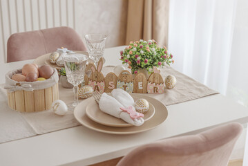 Festive Easter table setting with Easter bunny made from napkin. Easter celebration concept