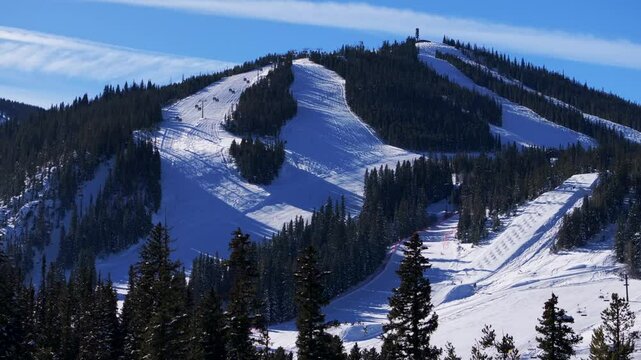 Winter Park Mary Jane Ski Resort moguls early morning blue sky groomed ski trails aerial drone Colorado Dark snowboard ski Territory Cirque double black diamond terrain chairlifts upwards motion