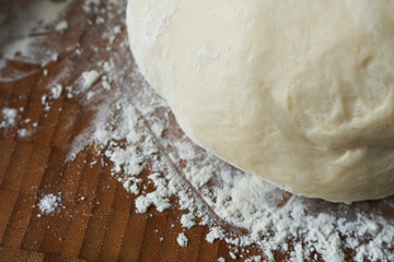 Raw dough with flour on a cutting board. Selective focus. Toned.