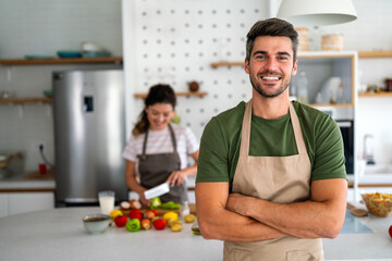 Professional personal chef cook in customer's private kitchen, giving a cooking lesson to people