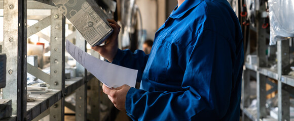 Worker works in a spare parts warehouse