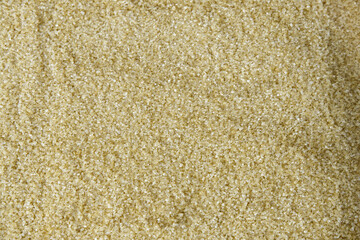 Brown sugar background. Close-up brown sugar texture for cooking ingredients, food texture, small, raw, sweet, palm plant, and organic concepts. Abstract brown texture background of palm sugar.
