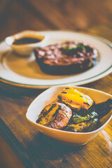 Grilled NZ Angus ribeye Steak served with homemade brown sauce, grilled vegetables